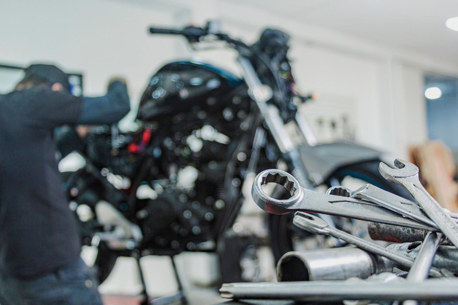 Motorcycle mechanics workshop, professional tools, selective focus.